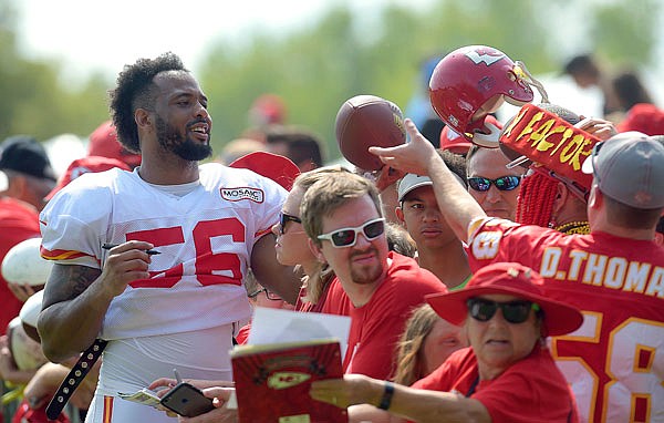Chiefs linebacker Derrick Johnson signs autographs after practice Tuesday in St. Joseph.