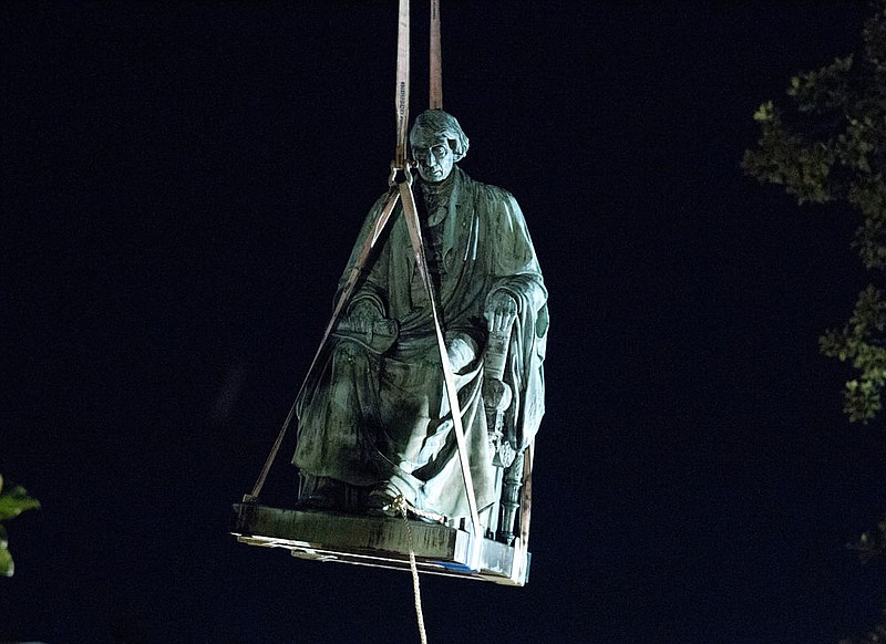 Workers use a crane to lift the monument dedicated to U.S. Supreme Court Chief Justice Roger Brooke Taney after it was was removed from outside Maryland State House, in Annapolis, Md., early Friday, Aug. 18, 2017. Maryland workers hauled several monuments away, days after a white nationalist rally in Charlottesville, Virginia, turned deadly.