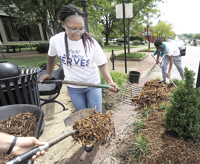 Freshmen Keyosha Blalock, Jermarcus Perkins and other Lincoln University students participate Thursday in the Day of Service around downtown Jefferson City. Participants planted, pulled weeds and picked up trash.