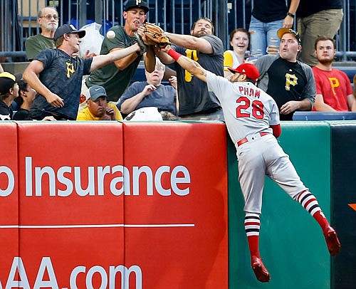 The ball bounces away from Cardinals left fielder Tommy Pham and the fans reaching for it as it goes into the stands for a two-run home run by Josh Harrison of the Pirates during the first inning of Thursday night's game in Pittsburgh.