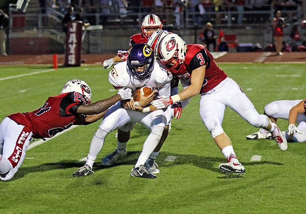 Jefferson City linebacker Elijah Jackson (left) helps bring down a Hickman rusher during a game last season at Adkins Stadium. Jackson is the top returning tackler for Jefferson City this season.