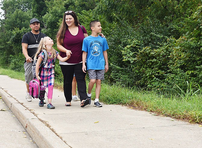 Enisa Rodriguez, 6, left, walks to school with her family Thursday morning at Cedar Hill Elementary School. Her mom, Brandy; brother, Eli, 11; dad, David; and sister, Ana, 12, behind Brandy, joined her on her way to her first day of first grade.