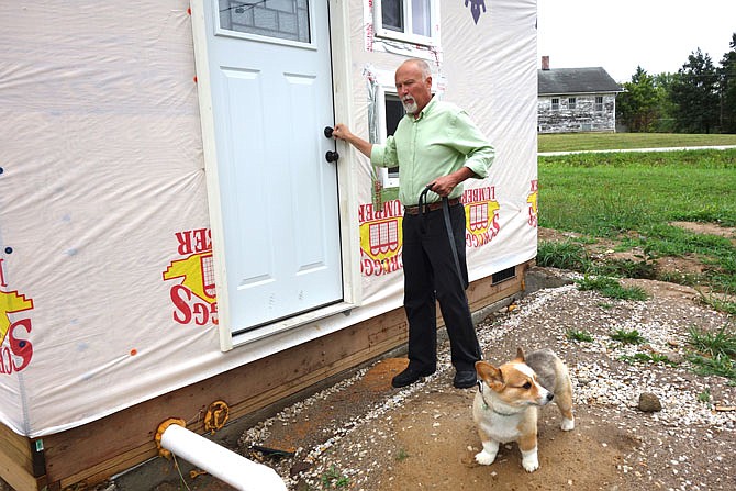 Stephen Gilpin enters his incomplete tiny house. He and general contractor Greg Rich suggest the house could be finished by the end of the year. Rich said it's taken half as much time to build as the 4,000-quare-foot house he recently completed.