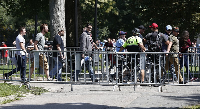 Organizers depart a "Free Speech" rally staged by conservative activists on Boston Common, Saturday, Aug. 19, 2017, in Boston.  One of the planned speakers of a conservative activist rally that appeared to end shortly after it began says the event "fell apart."Dozens of rallygoers gathered Saturday on Boston Common, but then left less than an hour after the event was getting underway. Thousands of counterprotesters had also gathered. (AP Photo/Michael Dwyer)