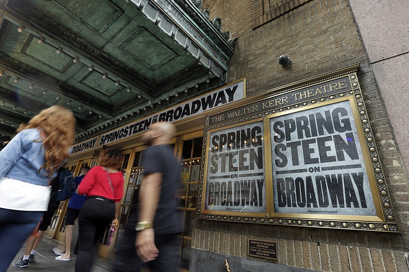 People pass the Walter Kerr Theater, home to the Broadway show "Springsteen on Broadway," in New York's Theater District, Friday, Aug. 18, 2017. The upcoming show will be the one of the latest to offer up tickets for sale using new technology, called Verified Fan, to try to keep re-sellers and brokers from snapping them all up. (AP Photo/Richard Drew)