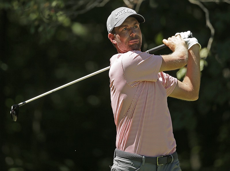 Webb Simpson watches his tee shot on the second hole during the third round of the Wyndham Championship golf tournament in Greensboro, N.C., Saturday, Aug. 19, 2017. (AP Photo/Chuck Burton)