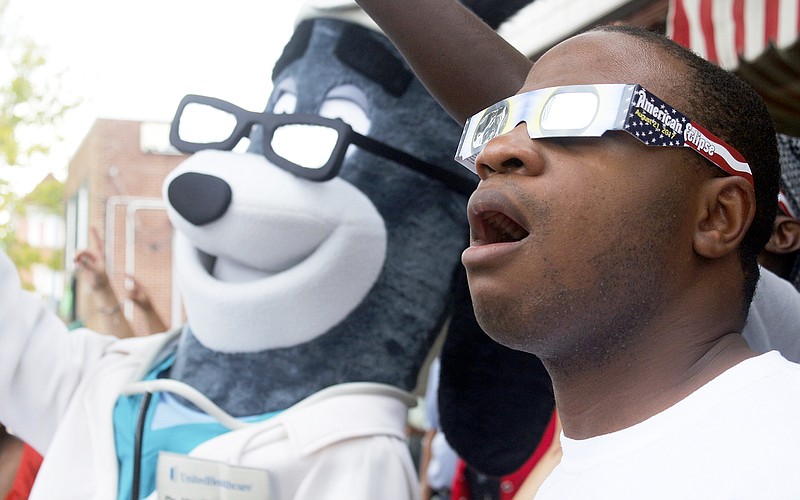 Davion Thomas stares up into the sky Friday, Aug. 18, 2017 alongside the United Healthcare Dr. Health Hound during a "mannequin challenge" at the United Healthcare Solar Eclipse Glasses Giveaway in front of Central Dairy in Jefferson City. "Our goal is to just help people be safe," United Healthcare Director of Marketing Stephanie Thomeczeh said. United Healthcare gave out 500 pairs of free eclipse glasses to Jefferson City residents to experience the 2017 eclipse.