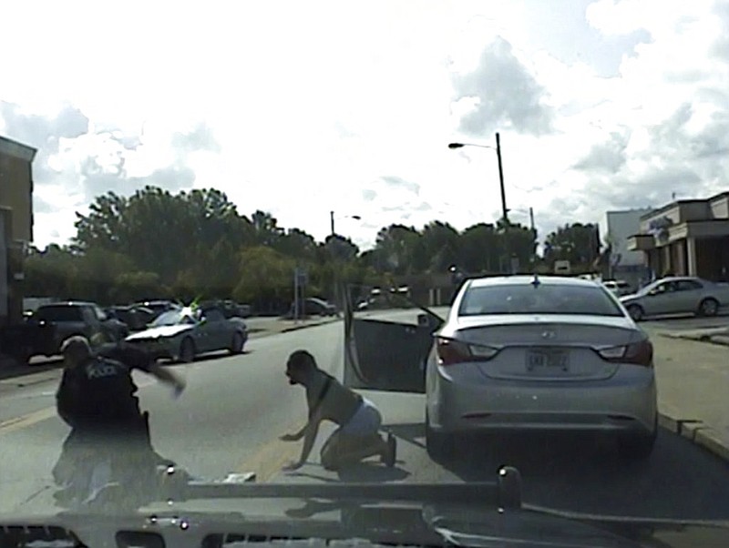 In this Saturday, Aug. 12, 2017 image taken from video provided by the Euclid Police Dept., Euclid police officer Michael Amiott punches Richard Hubbard on a street in Euclid, Ohio. A dashcam video of a traffic stop that led to a white police officer with a history of disciplinary issues repeatedly punching a black man and hitting his head on pavement appears to show a different sequence of events than police had originally described. (Euclid Police Dept. via AP)