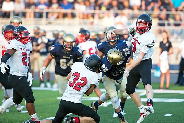 Coldon Imhoff of Helias disrupts the play of Hannibal quarterback Gabe Worthington during Friday night's game at Ray Hentges Stadium.