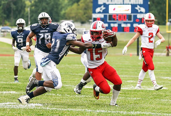 Jefferson City running back Maleek Jackson crosses the goal line for a touchdown before Jhabre Taylor of McCluer North can bring him down during Friday's game in Florissant.
