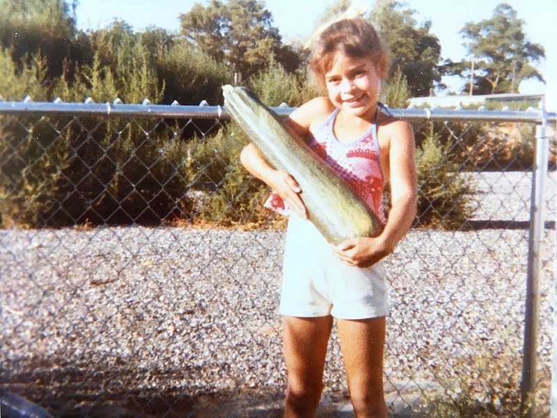 Lucy Luginbill's daughter, Tiffany, strikes a pose in the summer of 1978 with the zucchini that arrived at the right time.