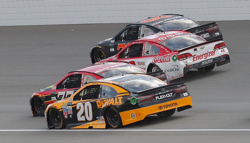 Matt Kenseth (20); Erik Jones (77); Kyle Larson (42) and Martin Truex Jr. (78) head into turn one on the last restart of the NASCAR Cup Series auto race in Brooklyn, Mich., Sunday, Aug. 13, 2017. Larson won the race. 