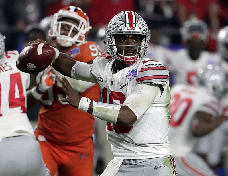 In this Dec. 31, 2016 file photo, Ohio State quarterback J.T. Barrett (16) looks to pass during the Fiesta Bowl NCAA college football game against Clemson in Glendale, Ariz. Barrett arguably is the best quarterback to ever play at Ohio State, but his issues with accuracy and decision-making along with inconsistent play from receivers and the offensive line contributed to the team's failings in big games last year, especially the 31-0 loss to Clemson in the playoffs.