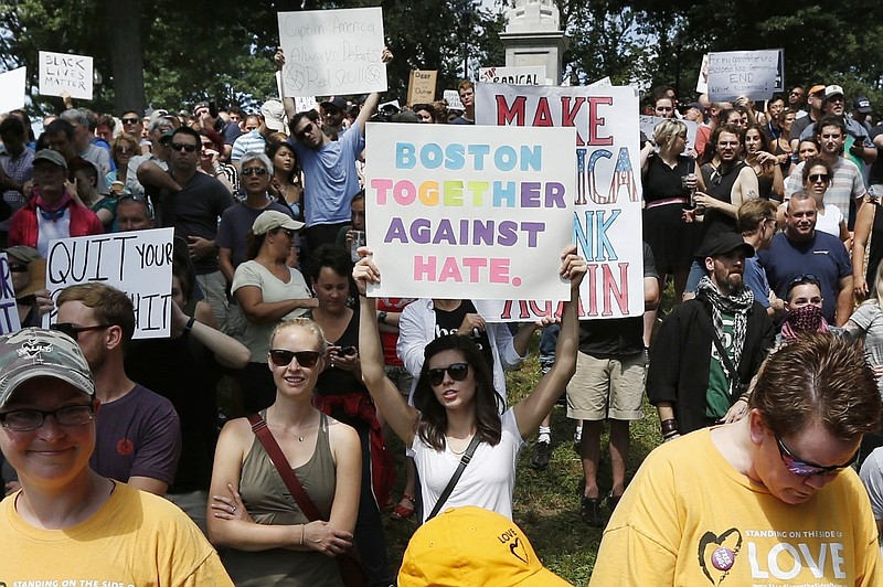 Counterprotesters hold signs at a "Free Speech" rally by conservative activists on Boston Common, Saturday, Aug. 19, 2017, in Boston. Thousands of demonstrators marched Saturday from the city's Roxbury neighborhood to Boston Common, where the "Free Speech Rally" is being held. (AP Photo/Michael Dwyer)