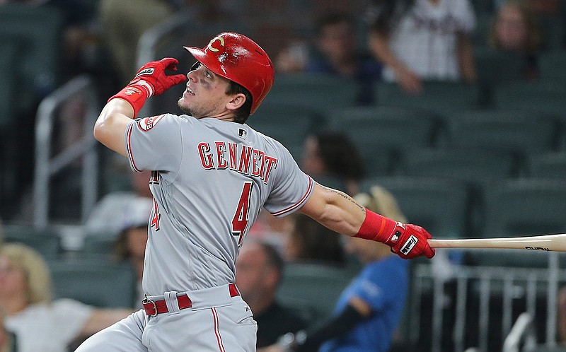 Cincinnati Reds second baseman Scooter Gennett (4) follows through on a grand slam in the ninth inning of a baseball game against the Atlanta Braves, Saturday, Aug. 19, 2017, in Atlanta. 