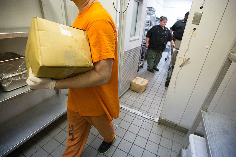 A Miller County Detention Center inmate stocks the freezer of the jail Wednesday. The Miller County Sheriff's Department has implemented several new policies following the December 2016 attack on two corrections officers that led to the death of officer Lisa Mauldin. 