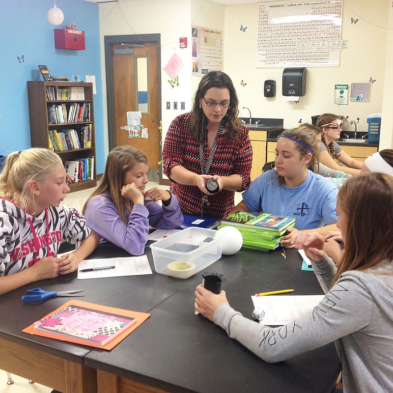 FILE: Jeannie Sneller, eighth grade science teacher from South Callaway Middle School, taught students how to make a model of an eclipse. From left are Hannah Mistler, Madison White, Jeannie Sneller, Madison Barnhart, Reagan Brown and Heidi Benningfield.