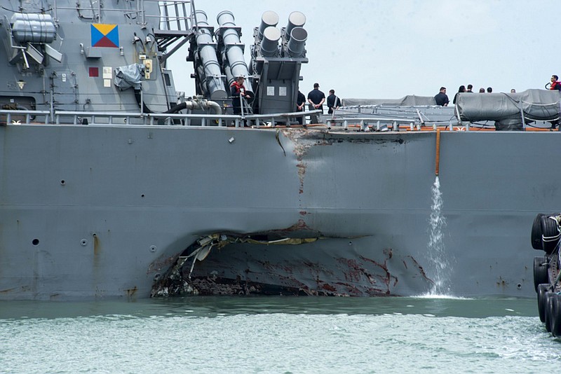 <p>AP</p><p>Damage to the portside is visible as the guided-missile destroyer USS John S. McCain steers towards Changi naval base in Singapore following a Monday collision with the merchant vessel Alnic MC.</p>