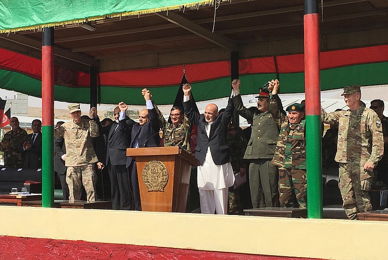 Afghan President Ashraf Ghani, to the right of the podium, is joined by top U.S. and Afghan military leaders for the launch of the Afghan Army's new special operations corp on Sunday, Aug. 20, 2017, at Camp Morehead, a training base southeast of Kabul.