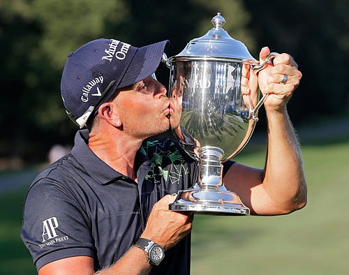 Henrik Stenson kisses the trophy Sunday after winning the Wyndham Championship in Greensboro, N.C.