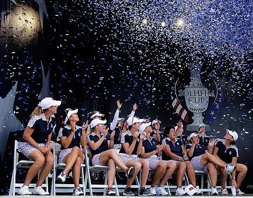 Members of the U.S. team celebrate as confetti starts to fall Sunday after winning the Solheim Cup in West Des Moines, Iowa.