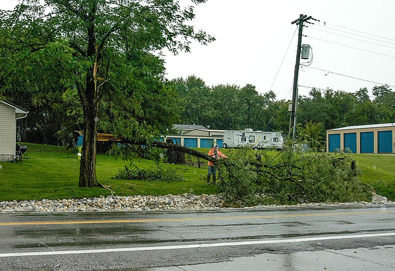 Pictured is California Street Department employee Scot Hern wielding a chain saw to cut up a down limb across Missouri 87 at Quail Hollow Road following an Aug. 16, 2017 storm.