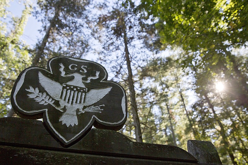 FILE - This Monday, Sept. 22, 2014 file photo shows the official Girl Scouts crest at the entrance of a Girl Scout Camp in Lapeer, Mich. As of March 2017, GSUSA reported 1,566,671 youth members and 749,008 adult members — down from just over 2 million youth members and about 800,000 adult members in 2014. (Erin Kirkland/The Flint Journal-MLive.com via AP)