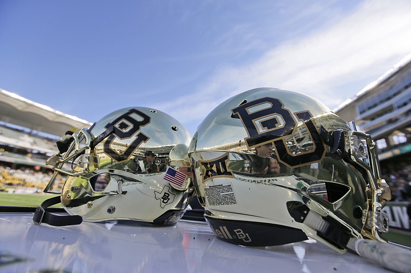 FILE - In this Dec. 5, 2015, file photo, Baylor helmets on shown the field after an NCAA college football game in Waco, Texas. For more than a year, the federal civil lawsuits against Baylor have piled in and piled on, accusing the nation's largest Baptist school of mishandling, ignoring or stifling claims of sexual and physical abuse of students for years. After months of bad publicity, the firing of a popular football coach and demotion and departure of a school president, Baylor is starting to make those cases go away with settlements as evidence gathering is just heating up and well before any of them approach trial. (AP Photo/LM Otero, File)