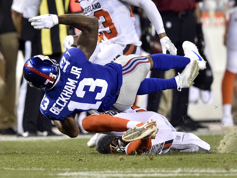 New York Giants wide receiver Odell Beckham (13) is tackled by Cleveland Browns strong safety Briean Boddy-Calhoun (20) in the first half of an NFL preseason football game, Monday, Aug. 21, 2017, in Cleveland. 