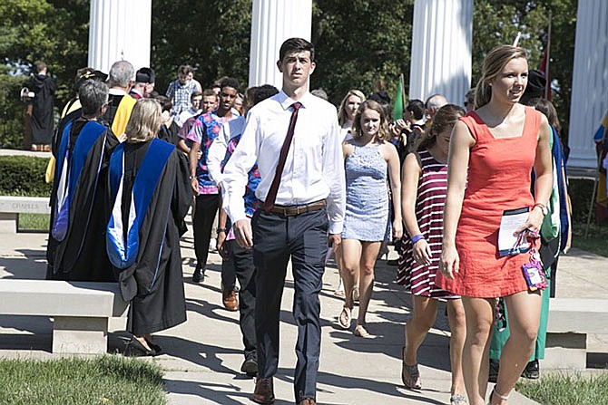 New students walk through the columns at Westminster College during the rite of passage ceremony.