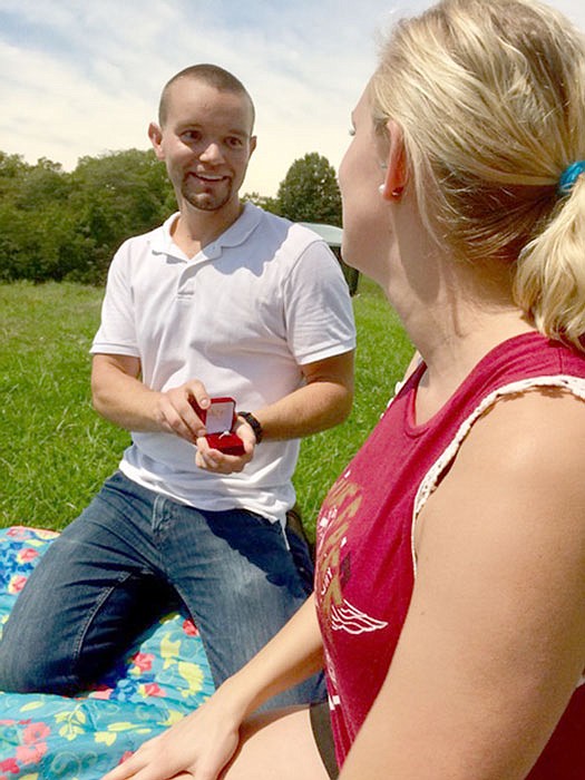 Max Bevell surprises girlfriend Samantha Booher by proposing during Monday's solar eclipse. 