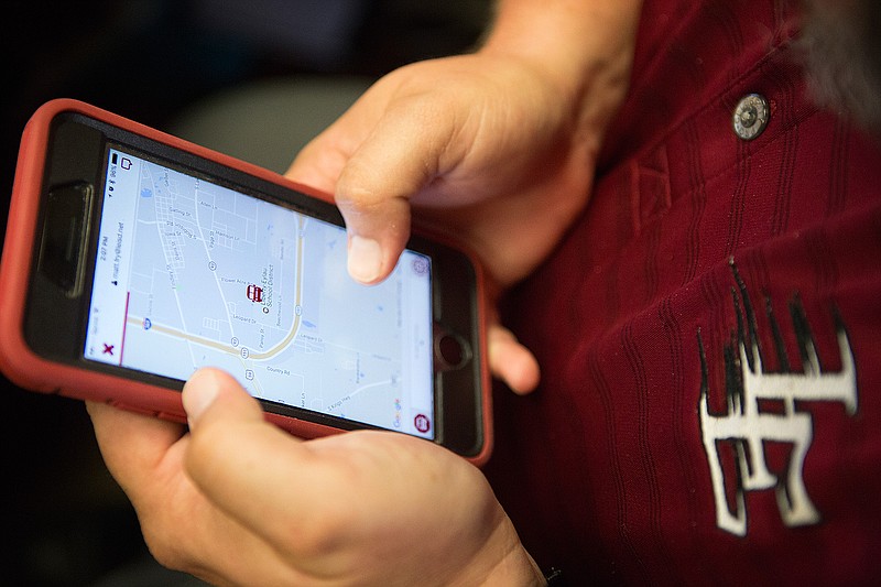 On Wednesday, Matt Fry, director of communications for Liberty-Eylau Independent School District, demonstrates some of the features parents will be able to take advantage of on the district's new bus locator app. Parents can track the location of their child's school bus and see the estimated time of arrival. 