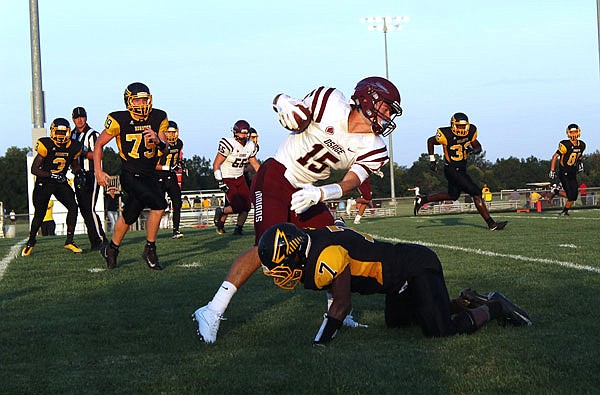 Fulton cornerback Makygh Galbreath tries to pull down School of the Osage senior wide receiver Drake Gaines during last Friday's game in Fulton.