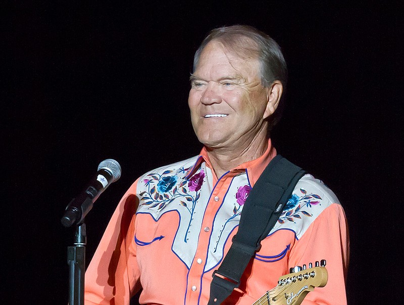 This Sept. 6, 2012 file photo shows singer Glen Campbell performing during his Goodbye Tour in Little Rock, Ark. Campbell, the grinning, high-pitched entertainer who had such hits as "Rhinestone Cowboy" and spanned country, pop, television and movies, died Tuesday, Aug. 8, 2017. He was 81. Campbell announced in June 2011 that he had been diagnosed with Alzheimer's disease. 