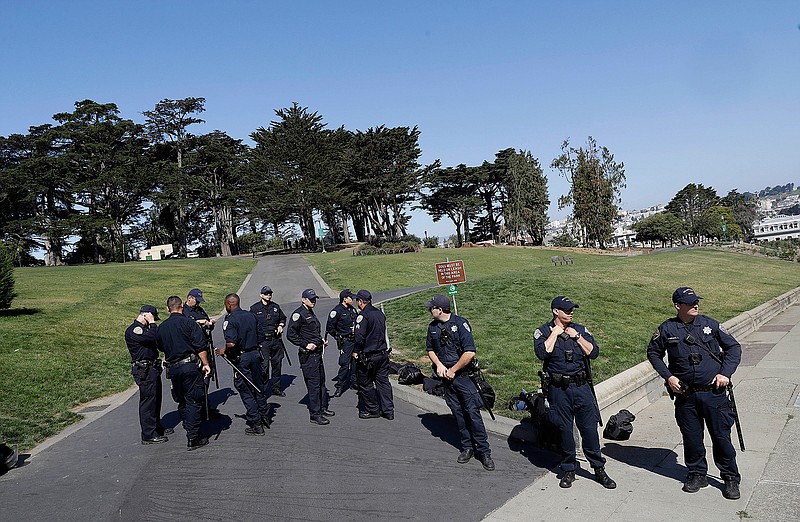 San Francisco Police Officers guard an entrance to Alamo Square Park in San Francisco, Saturday, Aug. 26, 2017. San Francisco officials took further steps Saturday to prevent violence ahead of a planned news conference by a right-wing group. Officials erected fencing and a large contingent of police monitored Alamo Square park, where the group Patriot Prayer was set to hold its event. 