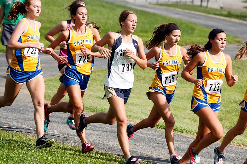 Emma Veltrop (center) of Helias runs with a group of Fatima cross country runners
Saturday, Aug. 26, 2017 in the Jim Marshall Invitational at Cole County Park.