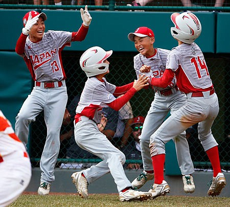 Japan's Seiya Arai (14) celebrates with teammates Sunday after scoring the game-ending run against Lufkin, Texas, at the Little League World Series in South Williamsport, Pa.