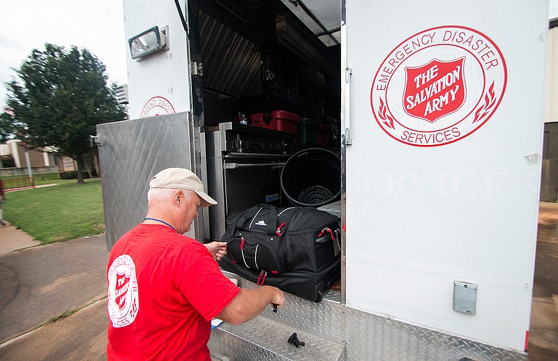 A volunteer loads his luggage into The Salvation Army Response Vehicle on Wednesday in Texarkana, Ark. Three local people from The Salvation Army will travel to South Texas to help Hurricane Harvey victims and provide hydration, food and spiritual healing. In two weeks, two more locals will be dispatched to the area.