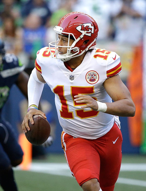 Chiefs quarterback Patrick Mahomes rolls out of the pocket against the Seahawks last Friday night in Seattle. Mahomes will start tonight's preseason game against the Titans.