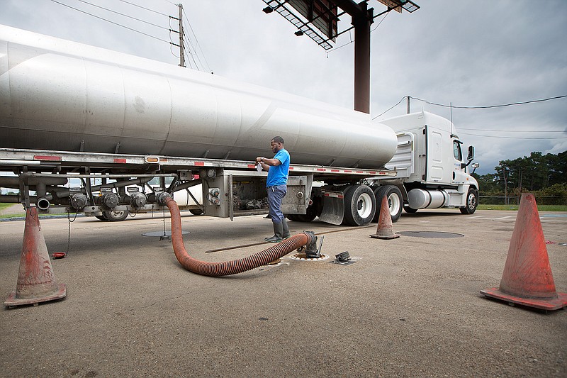 David Cook, with Central Arkansas Petroleum Transport, delivers a half tanker load of fuel Thursday afternoon to the E-Z Mart at Interstate 30 and State Line Avenue. The Texas Railroad Commission tweeted, "There is no fuel shortage." Officials from Quick Trip, RaceTrac, Truman Arnold Cos. and E-Z Mart repeated the message: Fuel is available and refinery capacity is already coming back online after Hurricane Harvey caused a 25 percent shutdown.