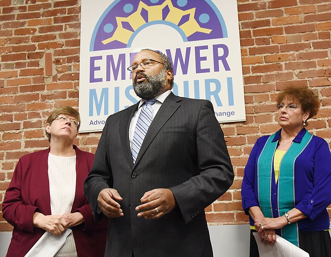 Jeanette Mott Oxford, executive director of Empower Missouri, left, and the Rev. Jeanie McGowan listen as Nimrod Chapel Jr., center, answers questions during a press conference Friday morning at the Empower Missouri office in downtown Jefferson City. Chapel is president of Missouri State Conference and local chapter of NAACP.