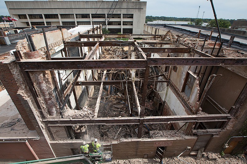 Crew members work on the alley side of the Kress building Tuesday in downtown Texarkana. The project is moving ahead and work should be completed by Oct. 1.
