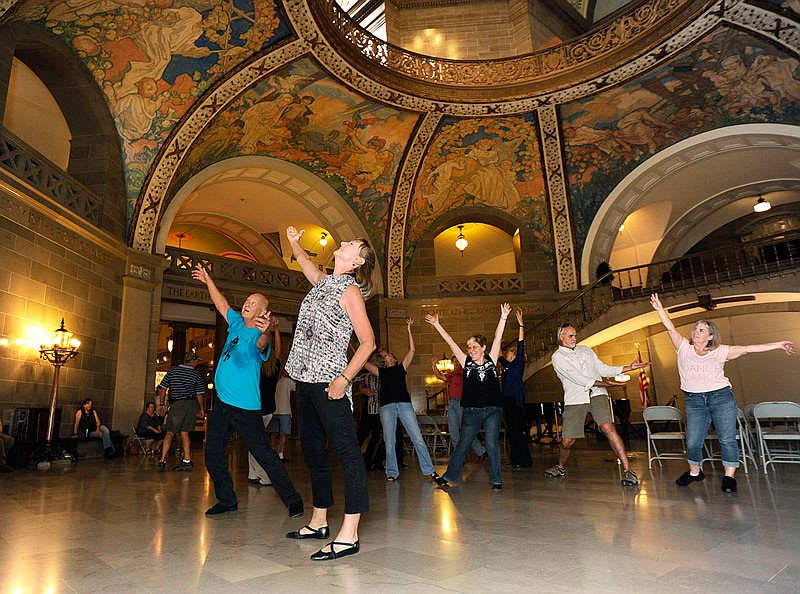 Couples strike their final pose at the end of Saturday's flash mob dance routine at the Missouri Capitol. The couples performed as a part of the International Flashmob West Coast Swing project. A video will be posted to YouTube in the hope Jefferson City will be featured on the highlight reel for the international project and event.