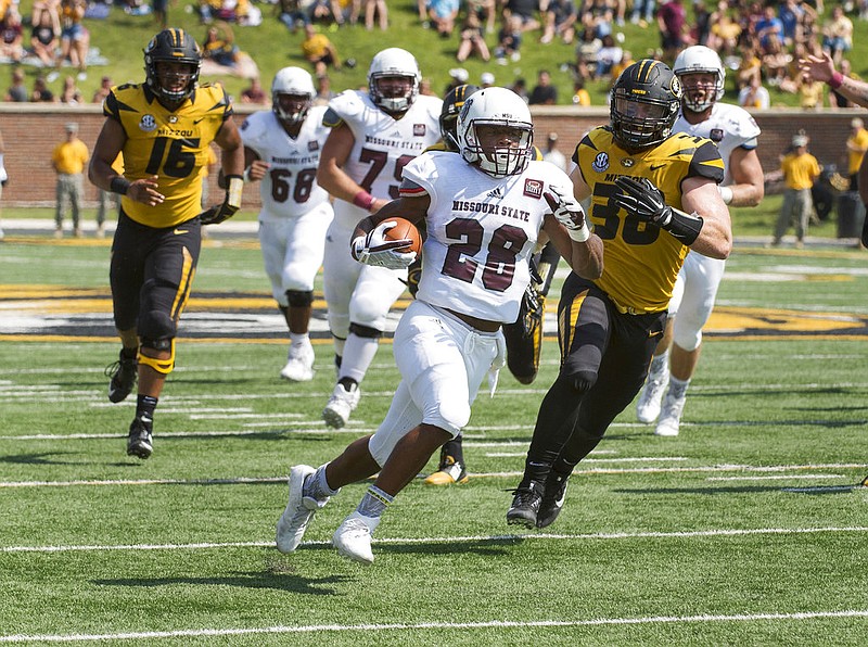 Missouri State running back Calan Crowder, center, runs past Missouri defensive lineman Marcell Frazier, left, and linebacker Eric Beisel, right, as he scores a touchdown during the first quarter of an NCAA college football game Saturday, Sept. 2, 2017, in Columbia, Mo. 