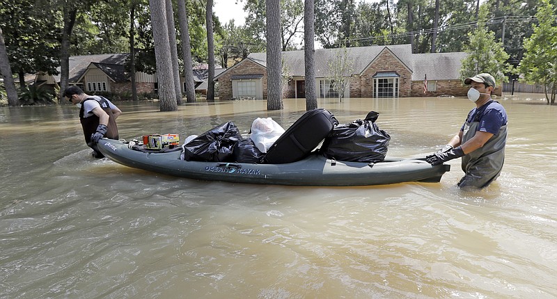 <p>AP</p><p>Gaston Kirby, left, is helped by friend Juan Minutella after gathering the last of his belongings Monday from his flooded home in the aftermath of Hurricane Harvey near the Addicks and Barker Reservoirs in Houston.</p>