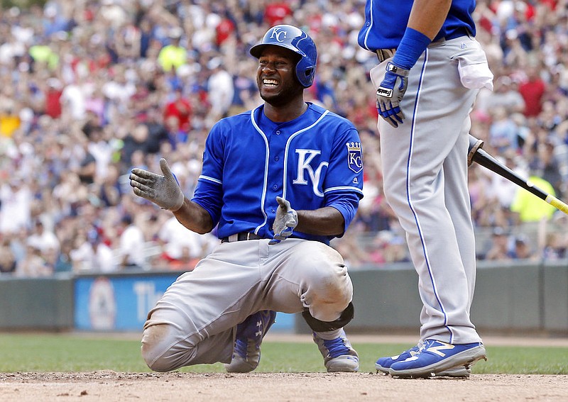 Kansas City Royals' Lorenzo Cain celebrates his two-run triple off Minnesota Twins pitcher Alan Busenitz despite being tagged out trying to advance home in the seventh inning of a baseball game, Sunday, Sept, 3, 2017, in Minneapolis. The Royals won 5-4. 