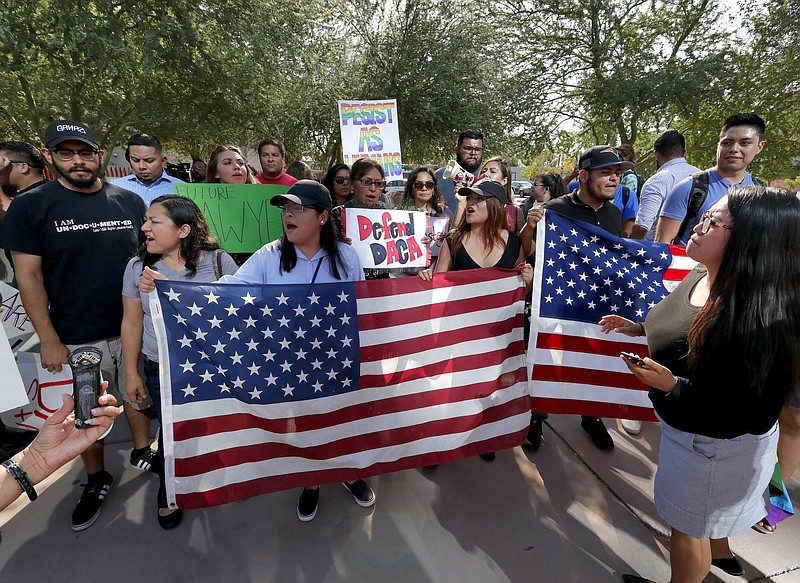 DACA supporters march to the Immigration and Customs Enforcement office to protest shortly after U.S. Attorney General Jeff Sessions' announcement that the Deferred Action for Childhood Arrivals (DACA), will be suspended with a six-month delay, Tuesday, Sept. 5, 2017, in Phoenix. President Donald Trump on Tuesday began dismantling the Deferred Action for Childhood Arrivals, or DACA, program, the government program protecting hundreds of thousands of young immigrants who were brought into the country illegally as children. (AP Photo/Matt York)