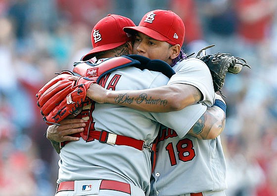 Cardinals starting pitcher Carlos Martinez gets hug from catcher Yadier Molina after throwing a complete-game shutout Monday in a 2-0 win against the Padres in San Diego.