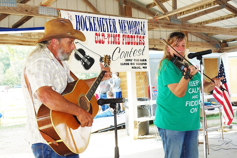 Kathy Summers of Bourbon, right, plays for the judges during the Old Fiddlers Contest. Like the man memorialized by the contest, Jake Hockemeyer, she's a left-handed fiddler. Her accompanist was Darrol Roskowske of St. James.