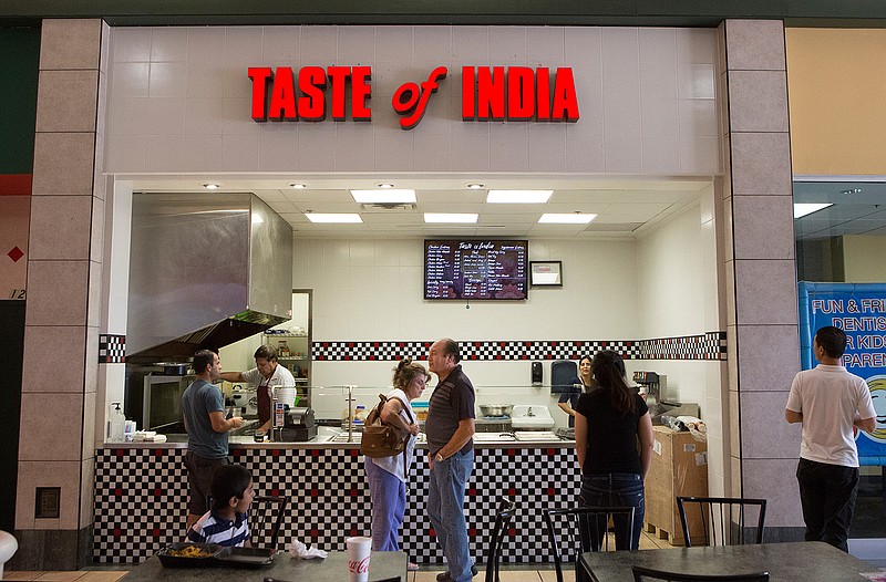 Customers mingle at A Taste of India at Central Mall. The new restaurant is at the spot previously occupied by Corn Dog 7. 
